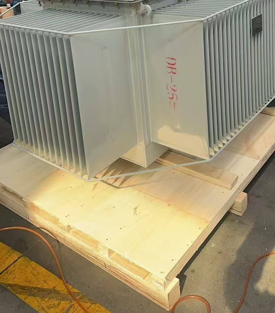 Oil-immersed transformer on a timber skid, with a stencilled marking on its tank