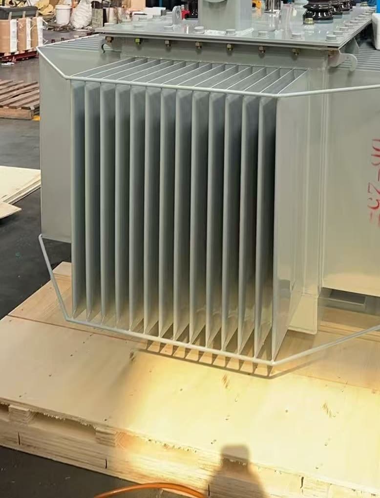 Oil-immersed transformer seen from the front, standing on a timber skid