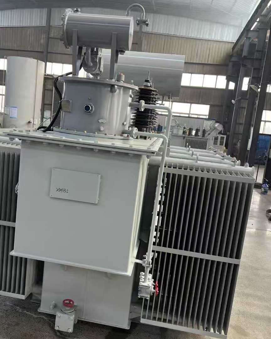 A large oil-immersed transformer seen from the front, with radiator banks, a conservator and an on-load tap-changer compartment