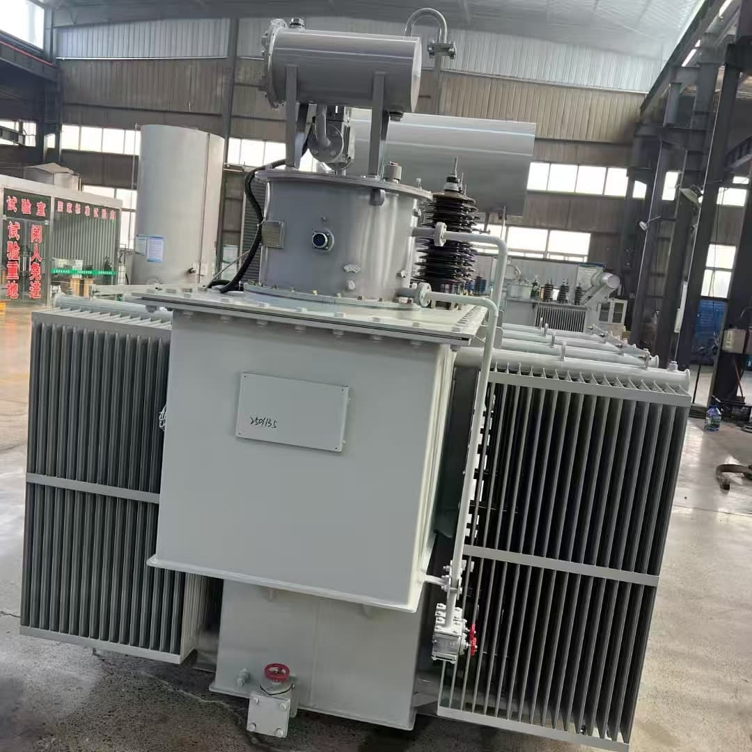 A large oil-immersed transformer seen from the front, with radiator banks, a conservator and an on-load tap-changer compartment