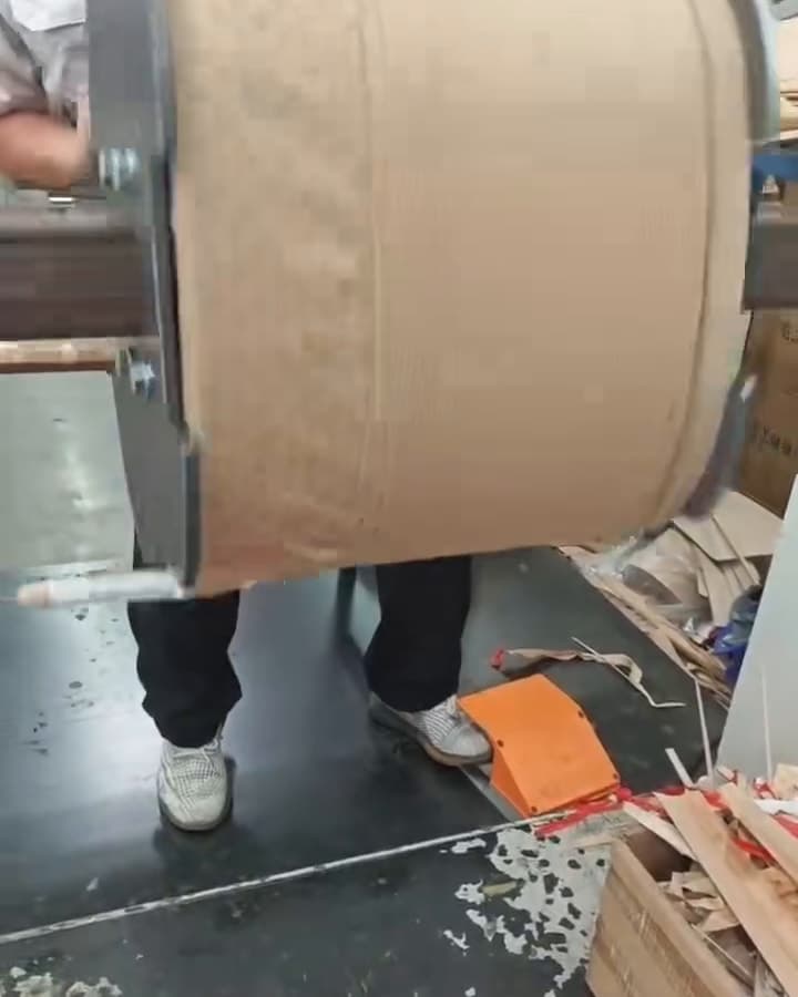 A coil wrapped in insulation paper turning on a winding machine